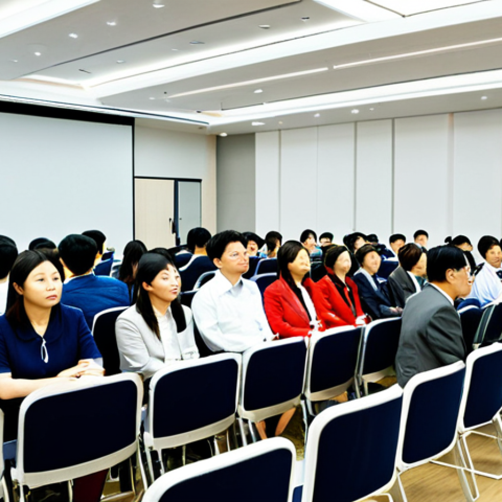 **Prompt:** A diverse group of educators attentively listening to a keynote speaker at a Korean language education conference, professional setting, fully clothed, appropriate attire, safe for work, perfect anatomy, natural proportions, bright lighting, modern conference hall.